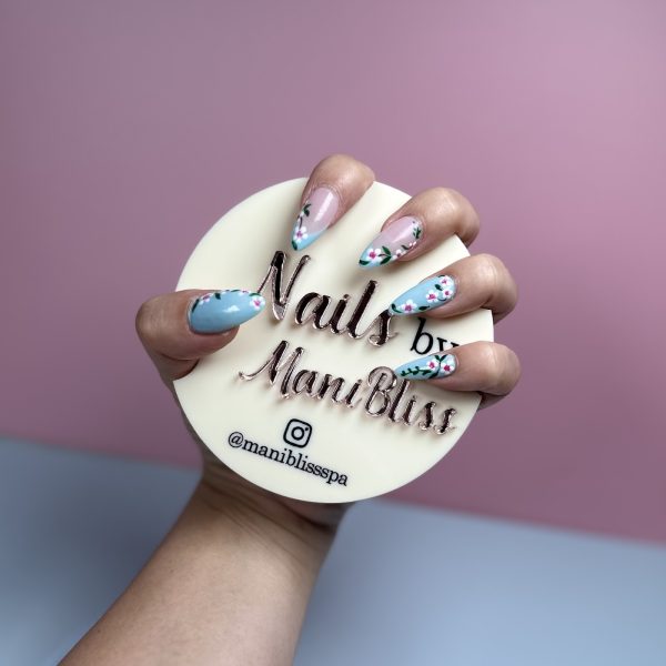 Light blue cherry blossom floral nail art on almond nails by ManiBliss nail salon Alpharetta GA