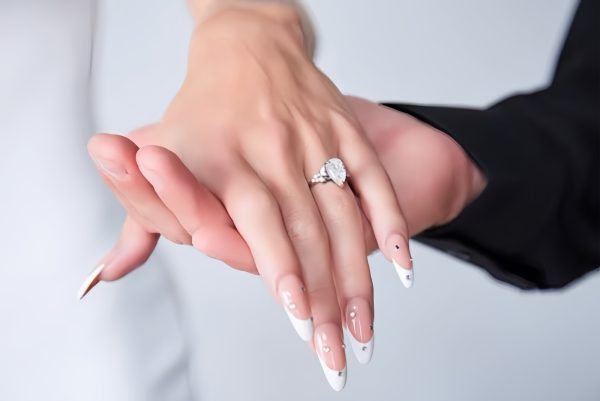 Elegant bridal French tip almond nails with pearl crystal accents by ManiBliss Organic Nails and Spa Alpharetta GA